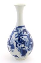 An Oriental blue and white bottle vase with a flared rim decorated with two women and children in an