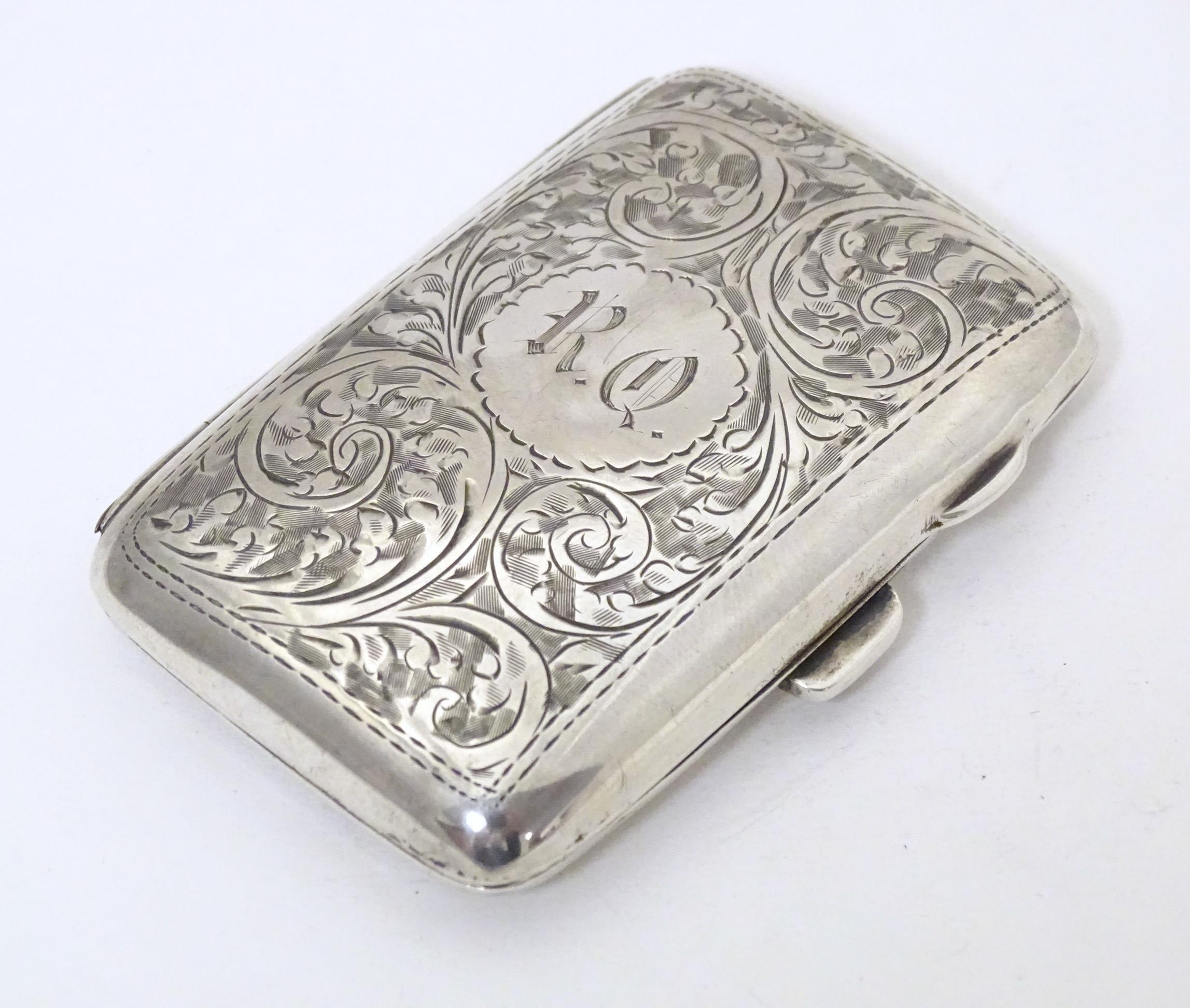 A silver cigarette case with engraved decoration, hallmarked Birmingham 1919, maker Joseph Gloster