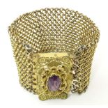 A Victorian pinchbeck bracelet set with amethyst coloured paste stone. Approx 7 1/2" x 1 1/2" Please