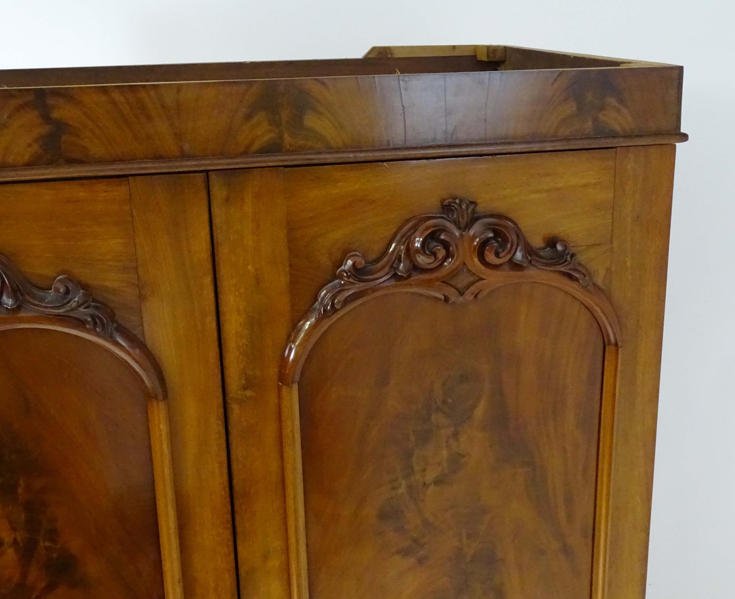 A mid 19thC mahogany double wardrobe with two panelled doors adorned with carved foliage and opening - Image 4 of 9