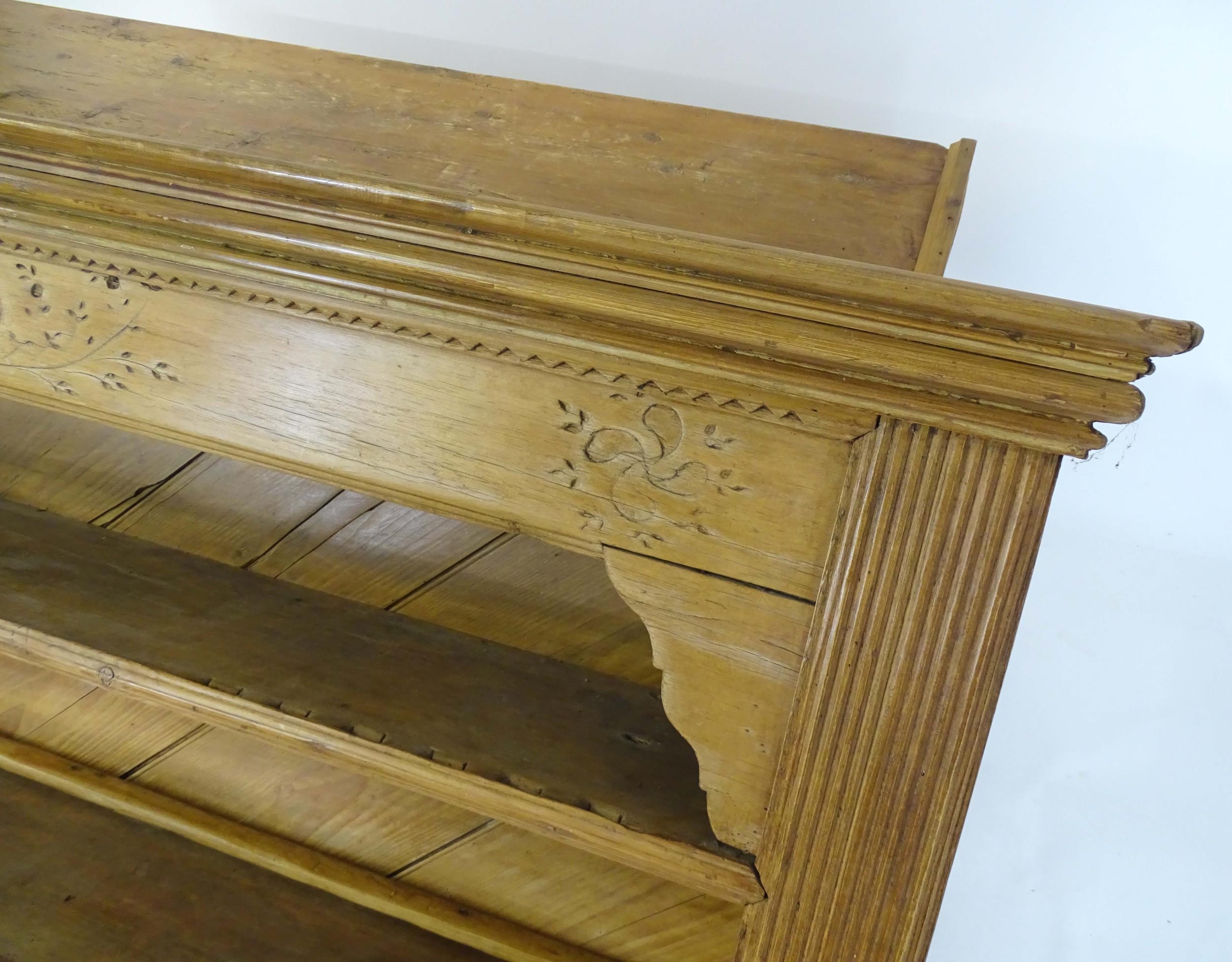 A 20thC pine dresser with a moulded cornice above floral carving flanked by reeded pilaster - Image 7 of 10