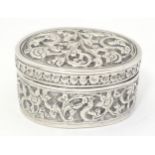 A Continental white metal pot and cover of oval form with embossed decoration. Approx. 2 1/4" x 1