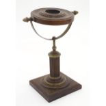 A 20thC stand with a fluted column surmounted by a rotating circular section. Possibly a pocket