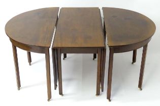 A late 18thC mahogany dining room table comprised of two D-ends and a drop leaf centre, standing