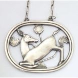Georg Jensen : A silver pendant necklace designed by Arno Malinowski depicting a kneeling deer.