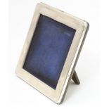 A easel back photograph frame of square form with a Continental .800 silver surround. Approx. 4 1/2"