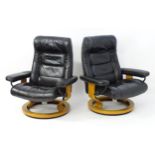 Two 20thC Scandinavian vintage black leather 'Stressless' reclining armchairs / lounge chairs with