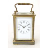 A carriage clock with white enamel dial. 5 3/4" high 'overall. Please Note - we do not make