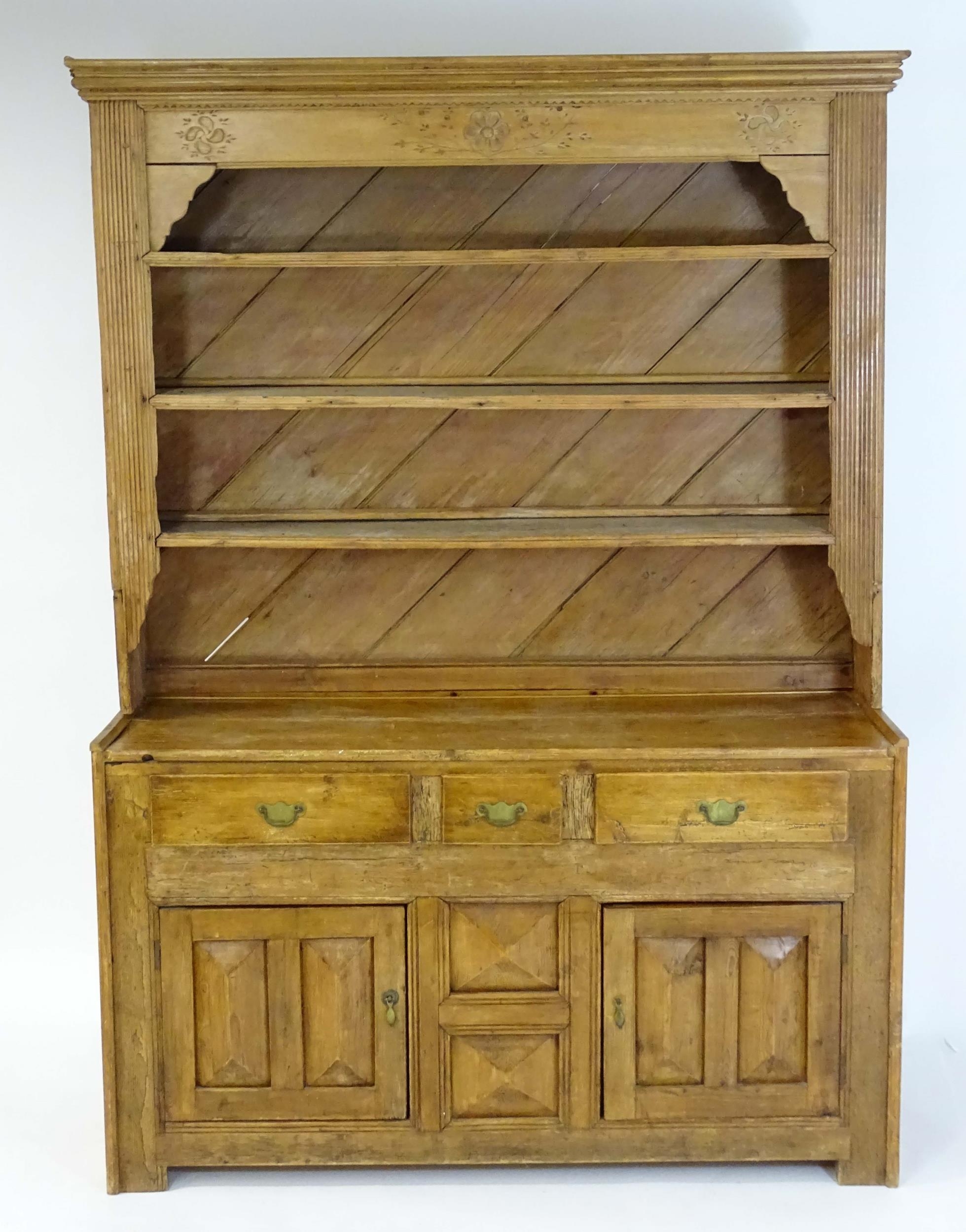 A 20thC pine dresser with a moulded cornice above floral carving flanked by reeded pilaster - Image 3 of 10