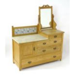 A late 19thC pine washstand / dressing table, with a carved mirror beside a marble top and tiled
