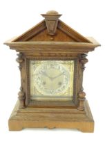 An oak cased Junghans mantel clock with silvered chapter ring having Arabic numerals and striking on