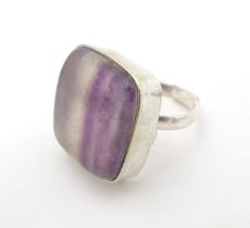 A silver dress ring set with blue john style cabochon to top. Please Note - we do not make reference