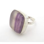 A silver dress ring set with blue john style cabochon to top. Please Note - we do not make reference