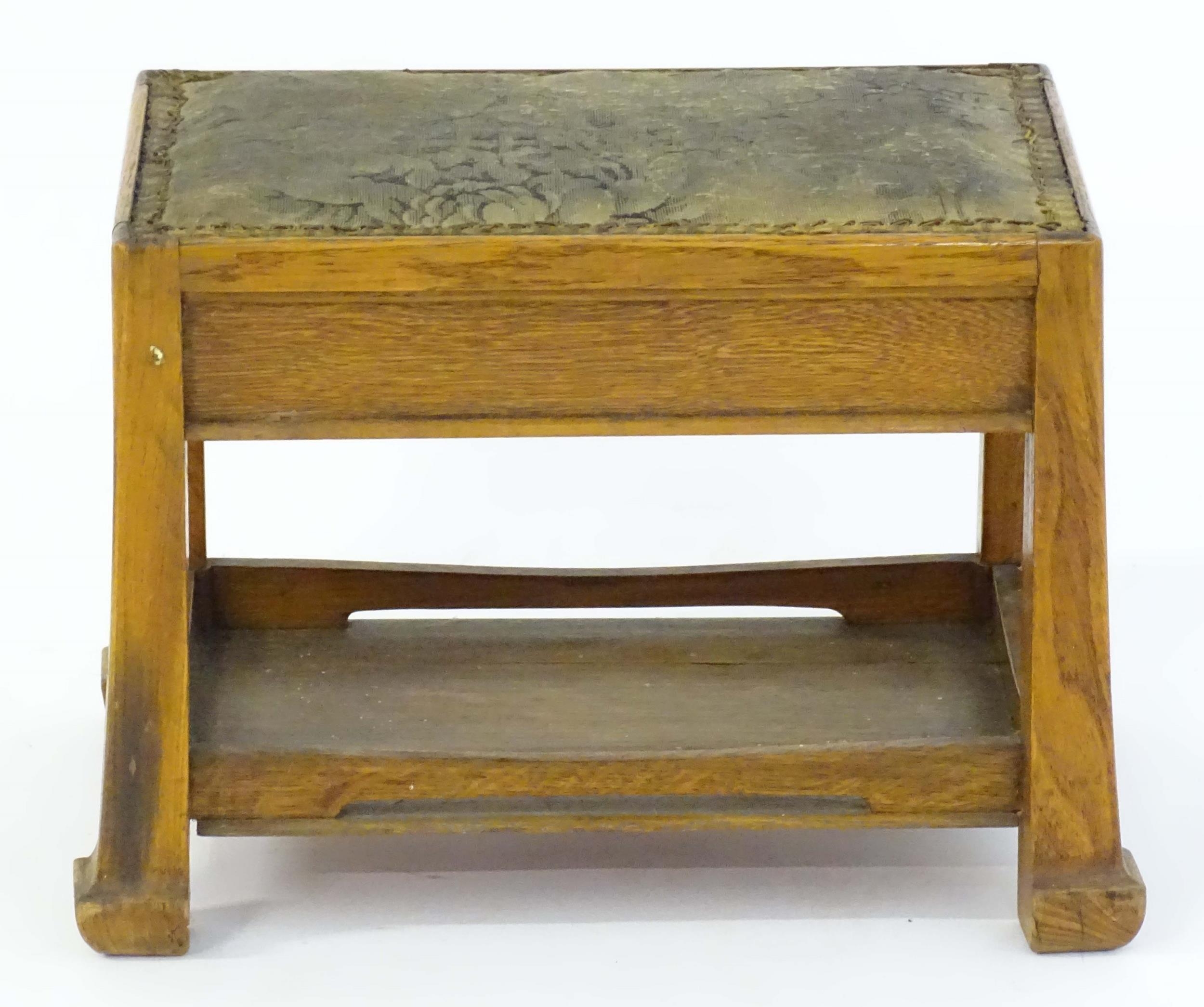 An Arts & Crafts oak footstool with an upholstered top above four tapering legs and an under tier - Bild 2 aus 4