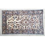 Carpet / Rug : A kashan rug with cream and beige ground and floral and foliate scroll detail.