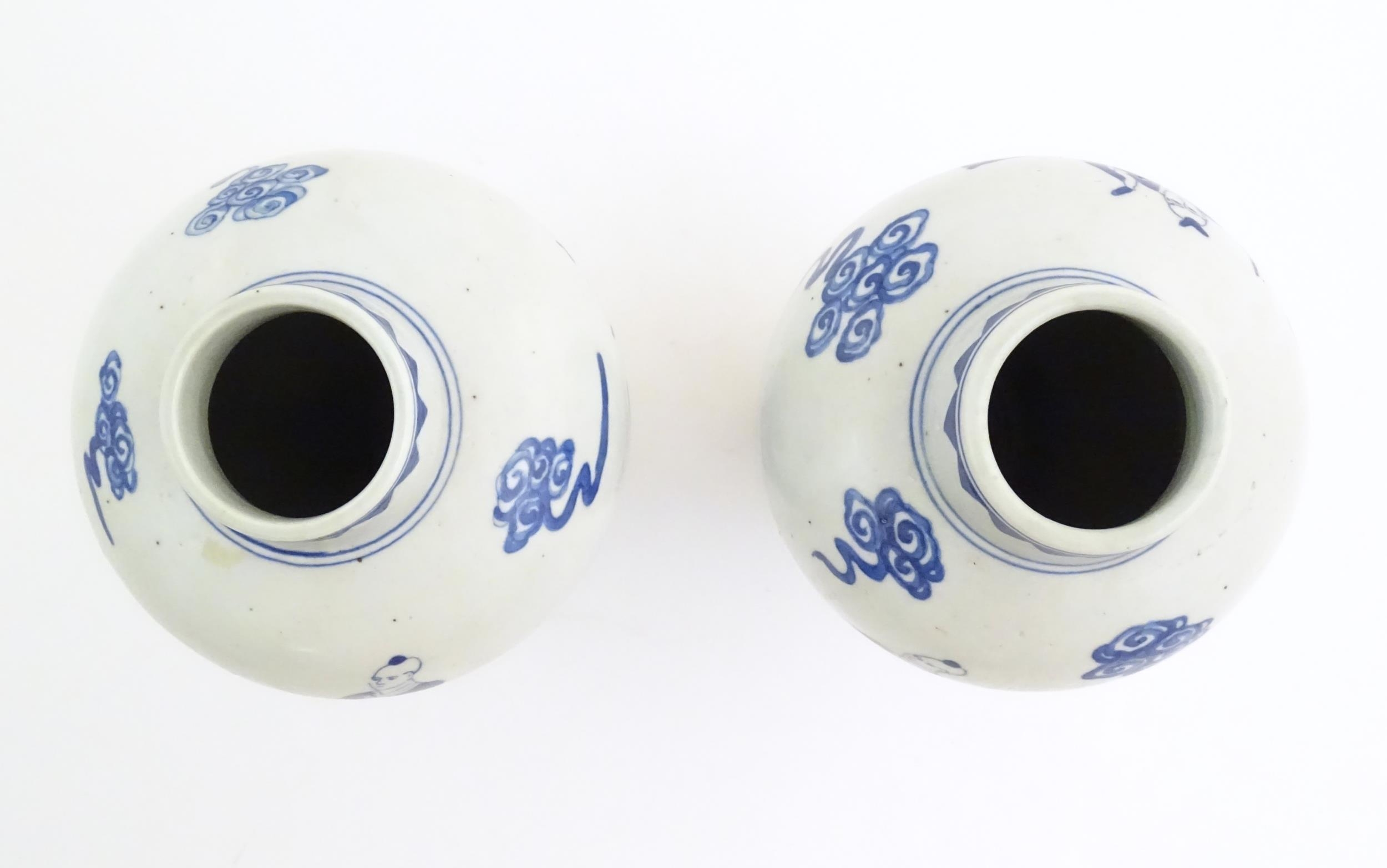 A pair of Chinese blue and white vases decorated with a Chinese dragon parade with figures in a - Image 6 of 6