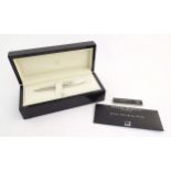 A cased silver Dunhill 'Torpedo' combination ballpoint & fountain dipping pen, hallmarked 2000