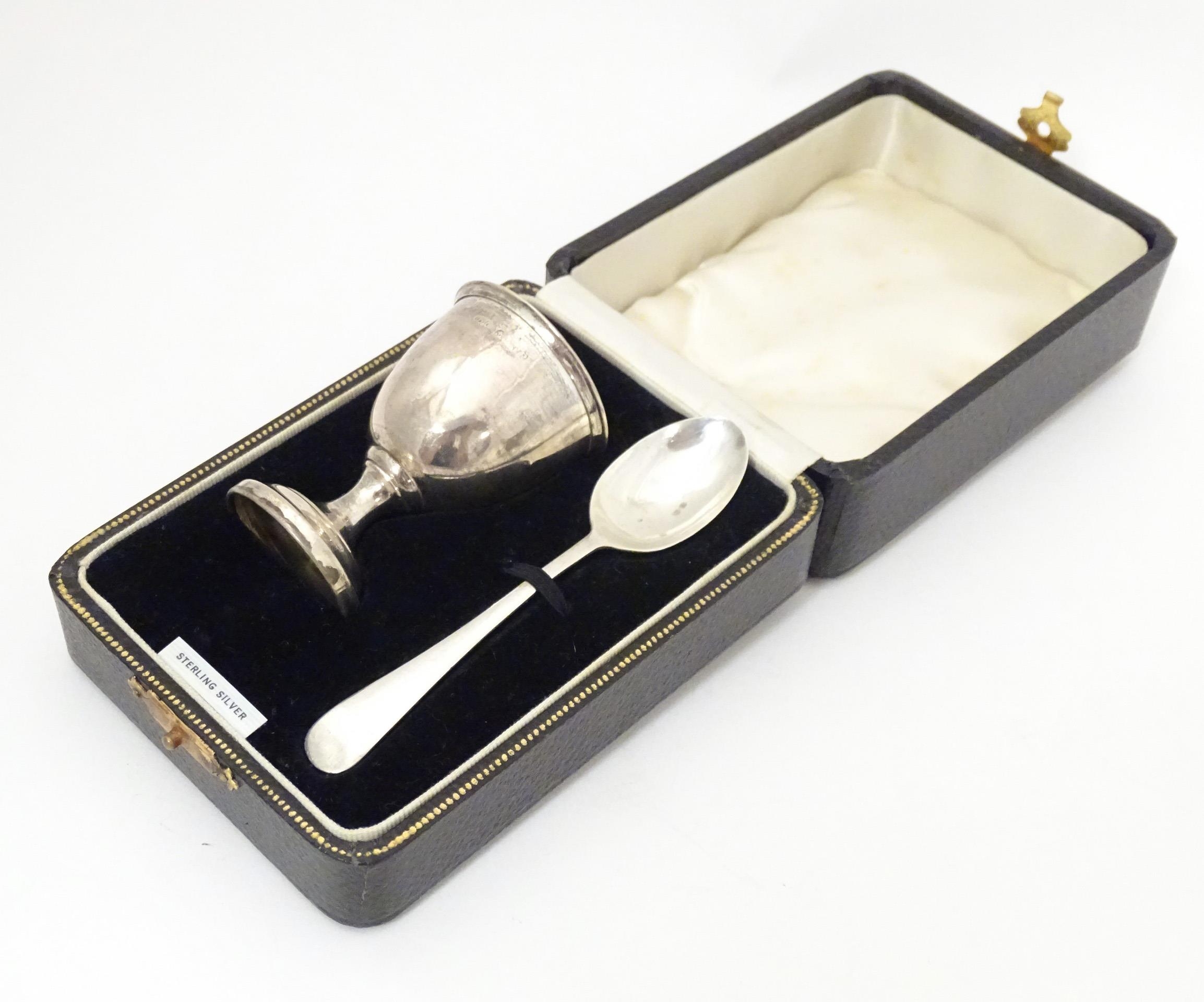 A silver egg cup and spoon, hallmarked Birmingham 1939, maker Arthur Price & Co, cased. The case