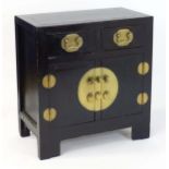 A Chinese black lacquered cabinet of rectangular form , having two short drawers above two cupboards