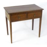 A Georgian walnut side table with a moulded top above two short drawers and raised on four