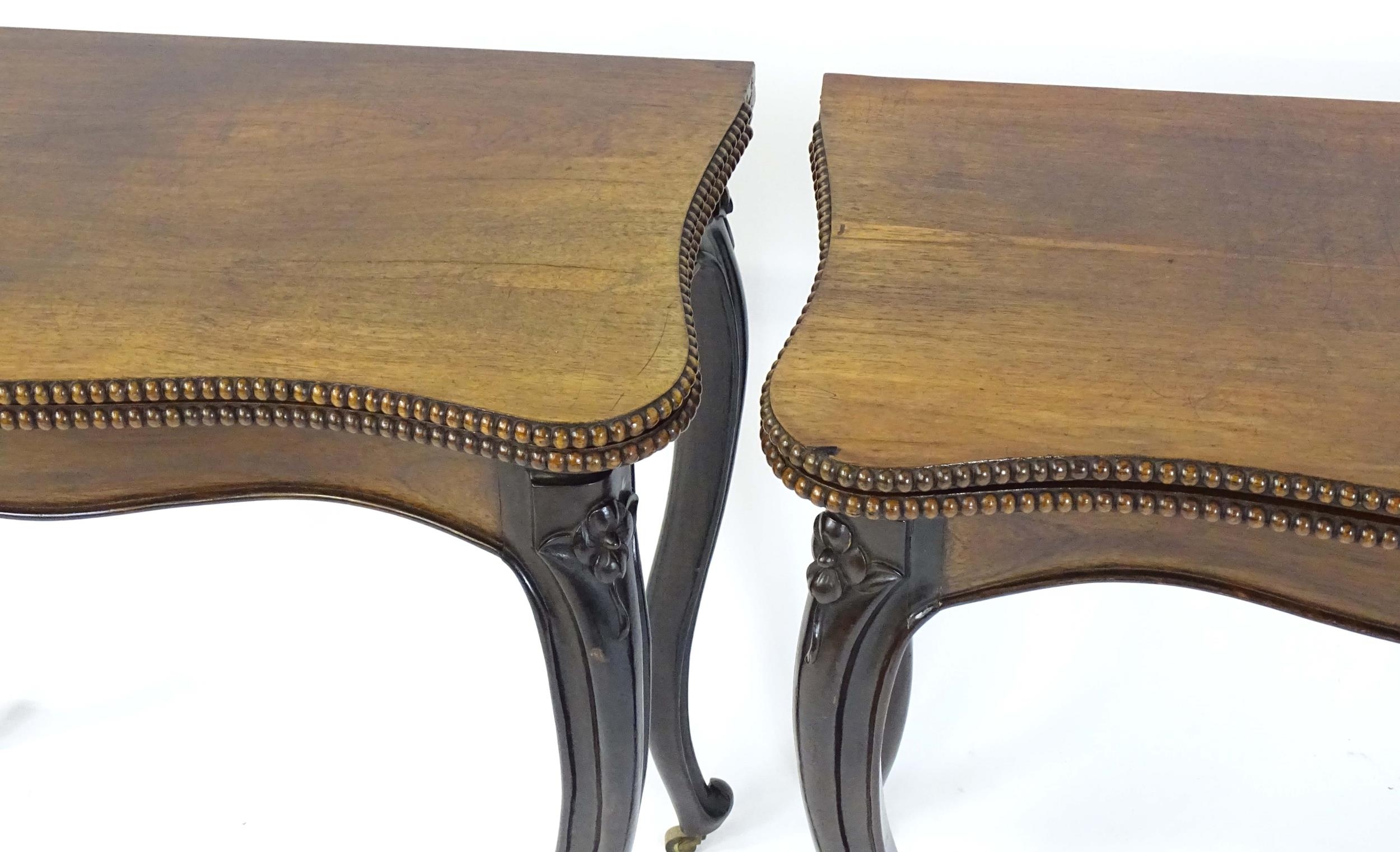 A pair of 19thC rosewood card tables of serpentine form, having beaded edges above floral carved - Image 9 of 18