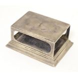 A silver match box case / table top stand hallmarked Birmingham 1902, maker Henry Matthews.