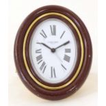 A Cartier Paris travel alarm clock with easel back. 3 1/2" high overall Please Note - we do not make