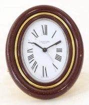 A Cartier Paris travel alarm clock with easel back. 3 1/2" high overall Please Note - we do not make