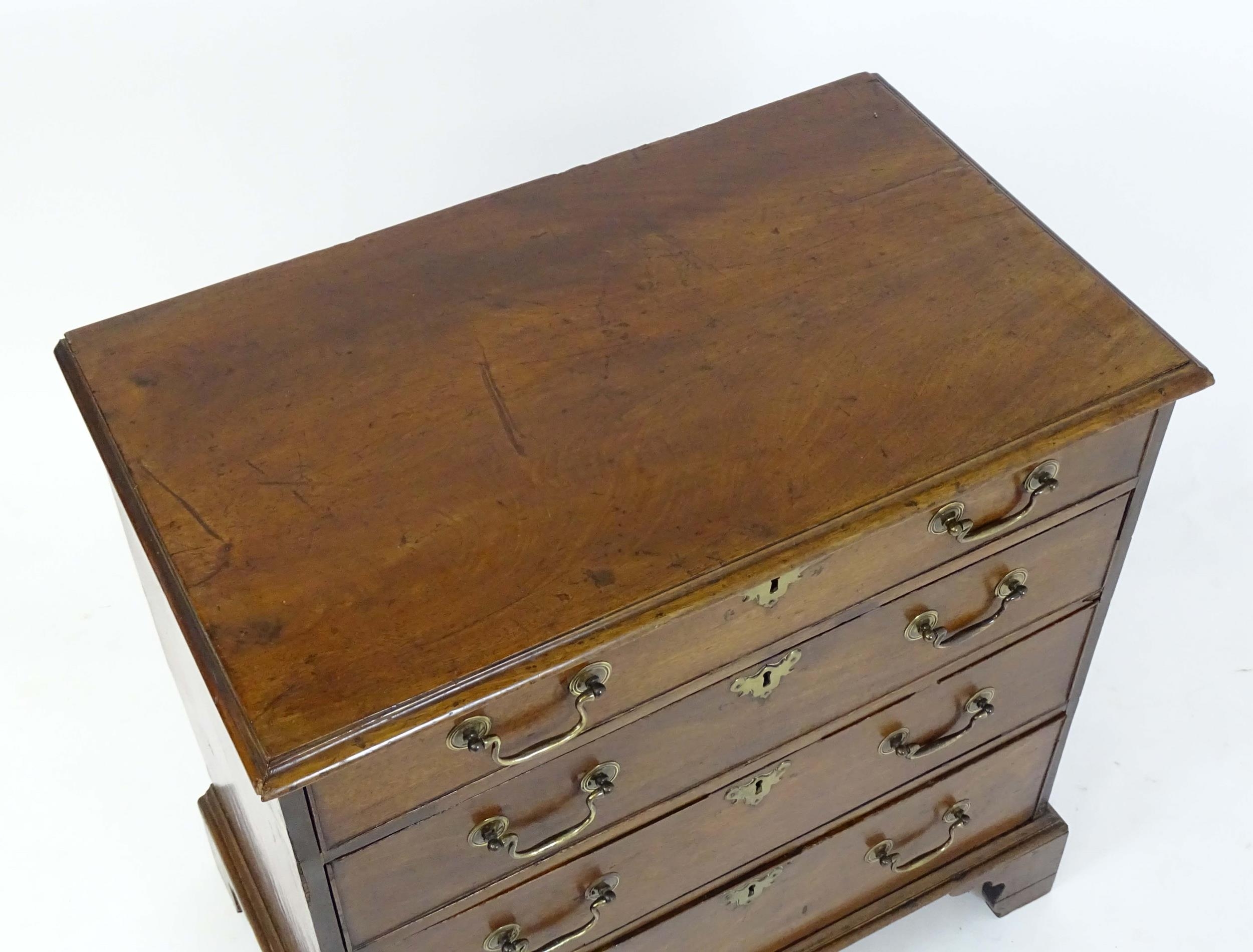 A Georgian mahogany chest of drawers with a moulded top above four long drawers with swan neck - Image 3 of 6