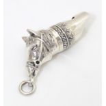 A white metal novelty whistle modelled as a horse. Approx. 1 3/4" long Please Note - we do not