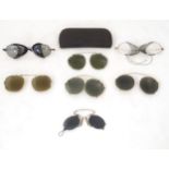 Five pairs of early 20thC clip-on sunglasses / shaded spectacles. Together with two pairs of glasses