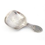 A Geo V silver caddy spoon with shell decoration to handle, the bowl engraved 1848-1928,