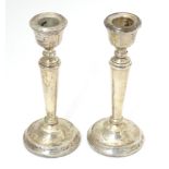 A pair of silver candlesticks hallmarked Birmingham 1987, maker A. T. Cannon Ltd. Approx. 6 1/4"