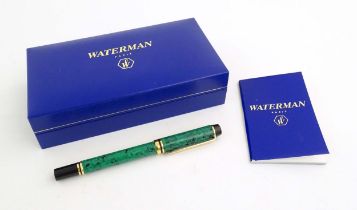 A cased Waterman 'Le Man 200' fountain pen, with green/black marbled finish and 18K gold nib.