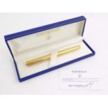 A cased Waterman, Paris 'Ideal' fountain pen, with engine turned decoration, gold plated finish