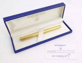 A cased Waterman, Paris 'Ideal' fountain pen, with engine turned decoration, gold plated finish