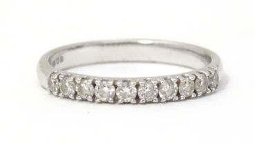 A 9ct white gold ring set with 10 diamonds in a linear setting . Ring size approx L. Please Note -