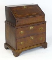 A late 17thC / early 18thC oak two part bureau, having a fall front with crossbanded inlay, the fall