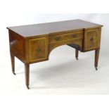 A mid 19thC mahogany desk with an inverted break front top having cross banded decoration to the top