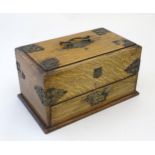 A Victorian oak smokers companion box with applied mounts and handles, opening to reveal various
