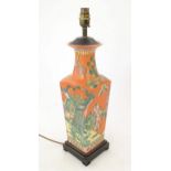 A 20thC Oriental lamp base of squared tapering form decorated with peacocks and phoenix birds in a