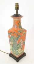 A 20thC Oriental lamp base of squared tapering form decorated with peacocks and phoenix birds in a