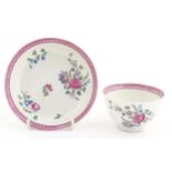 An English late 18th / early 19thC tea bowl and saucer with hand painted floral decoration and a