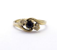A 9ct gold ring set with central blue spinel flanked by diamonds. Ring size approx. N Please