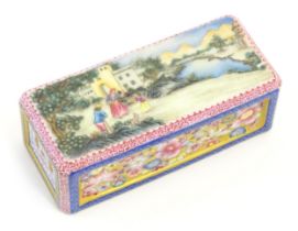 A Chinese famille rose paperweight decorated with a figures in a landscape scene, the sides with