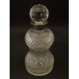A cut glass decanter with silver collar hallmarked London 1937. 10" high overall Please Note - we do