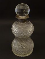 A cut glass decanter with silver collar hallmarked London 1937. 10" high overall Please Note - we do