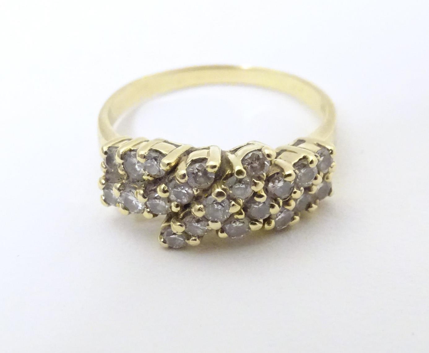 An 18ct gold dress ring set with 21 diamonds. Ring size approx P Please Note - we do not make