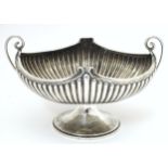 A late 19th / early 20thC silver bowl of fluted oval form with twin handles. Indistinctly signed
