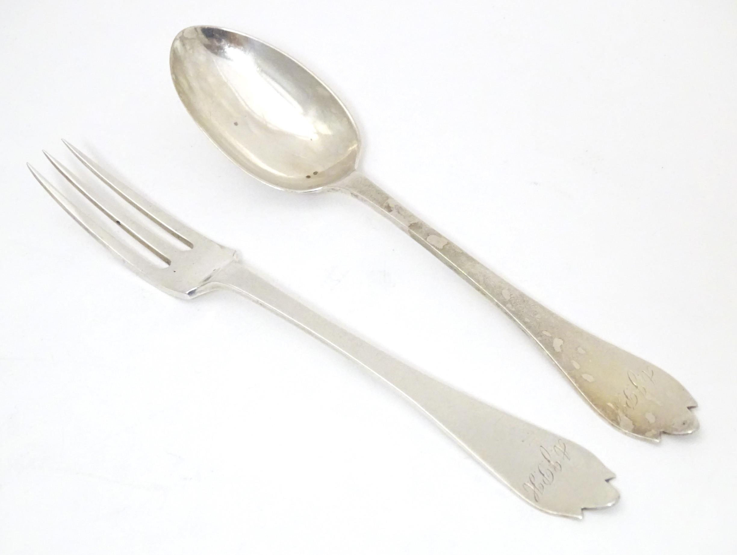 A silver christening fork and spoon with trefid handles hallmarked London 1911 maker Josiah Williams
